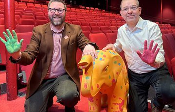 Two men and an small elephant sculture