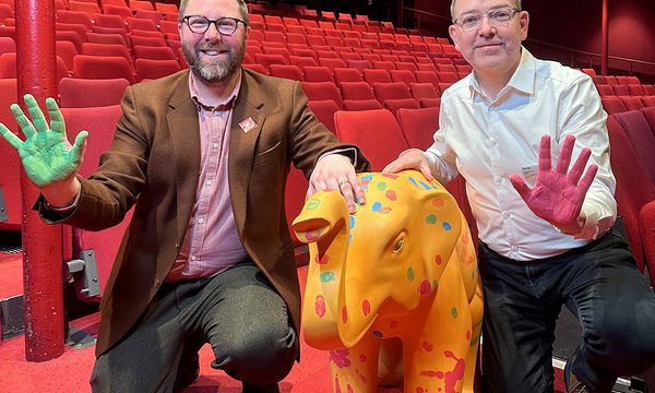 Two men and an small elephant sculture
