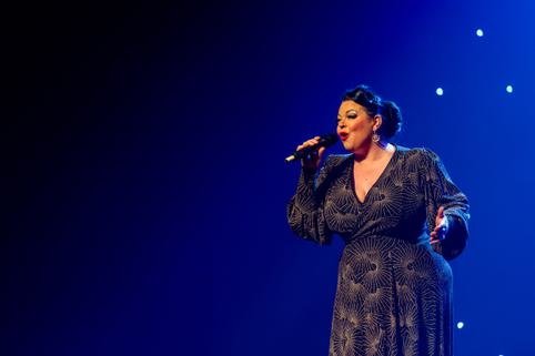 A woman on stage singing