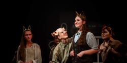 Four actors on stage in the production of Animal Farm