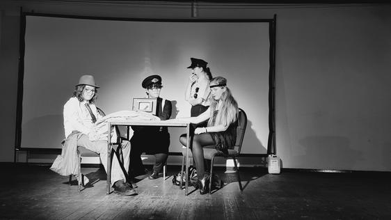 Four young actors on stage in a play