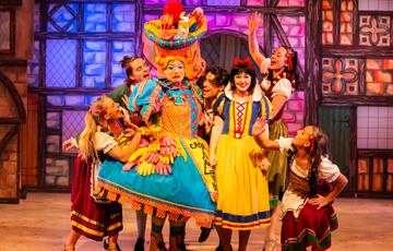 Snow White cast grouped together on stage