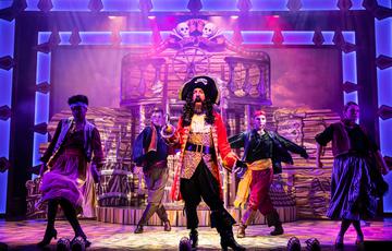 Captain Hook on stage with his crew in Peter Pan Pantomine