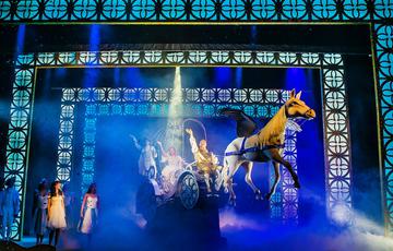 A flying horse and carriage coming over the audience heads carrying cinderella