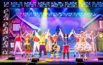 Jack & The beanstalk cast on stage with hands in the air